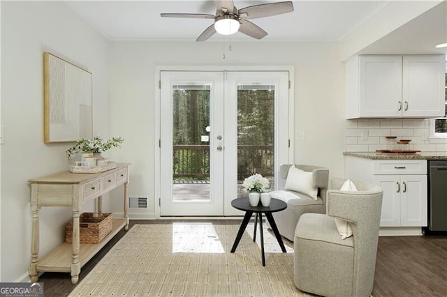 doorway featuring french doors, wood finished floors, baseboards, visible vents, and ceiling fan