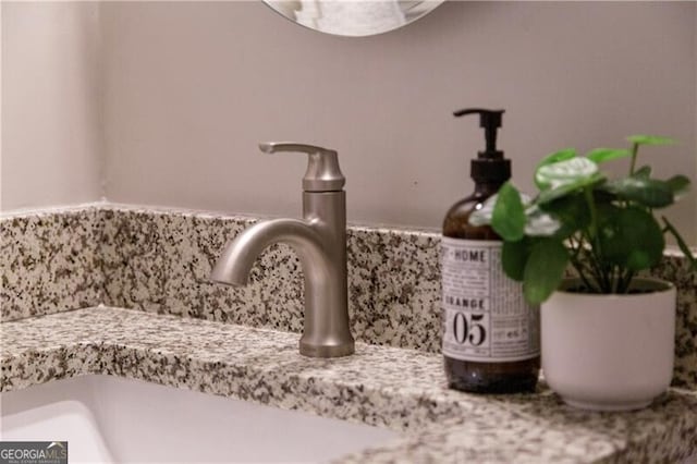 interior details with decorative backsplash and a sink