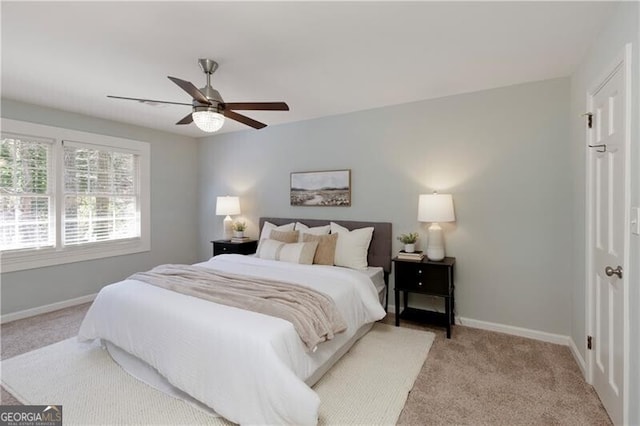 bedroom with baseboards, ceiling fan, and light colored carpet