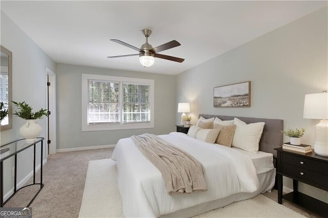 carpeted bedroom with baseboards and a ceiling fan