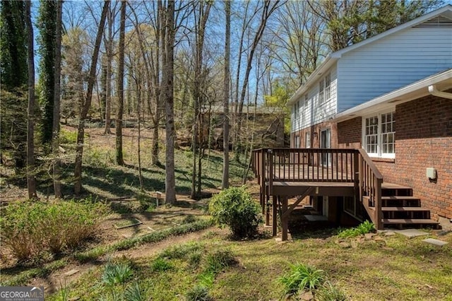 view of yard with stairs and a deck
