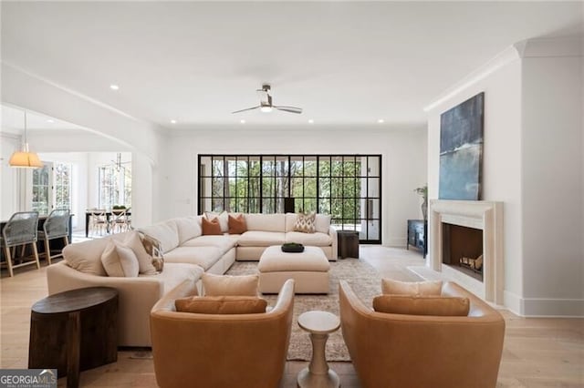 1074 Moores Mill Rd NW, Atlanta, GA 30327 - living room with arched walkways, a ceiling fan, recessed lighting, light wood-style floors, and a fireplace