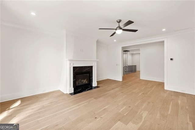 1074 Moores Mill Rd NW, Atlanta, GA 30327 - unfurnished living room featuring ornamental molding, a ceiling fan, light wood-style floors, a high end fireplace, and recessed lighting