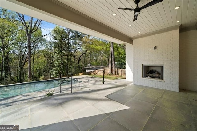 1074 Moores Mill Rd NW, Atlanta, GA 30327 - view of patio / terrace with an outdoor brick fireplace, a ceiling fan, view of scattered trees, and an outdoor pool