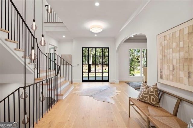 1074 Moores Mill Rd NW, Atlanta, GA 30327 - entrance foyer with wood finished floors, arched walkways, recessed lighting, and stairway