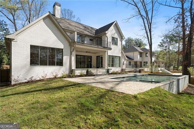 1074 Moores Mill Rd NW, Atlanta, GA 30327 - rear view of house with a balcony, a patio area, a chimney, a yard, and an outdoor pool