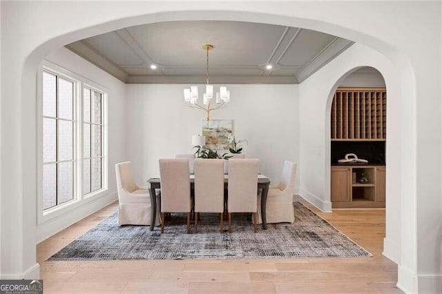 1074 Moores Mill Rd NW, Atlanta, GA 30327 - dining room featuring wood finished floors, a chandelier, recessed lighting, and arched walkways