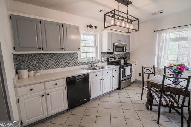 kitchen with visible vents, a sink, tasteful backsplash, and appliances with stainless steel finishes