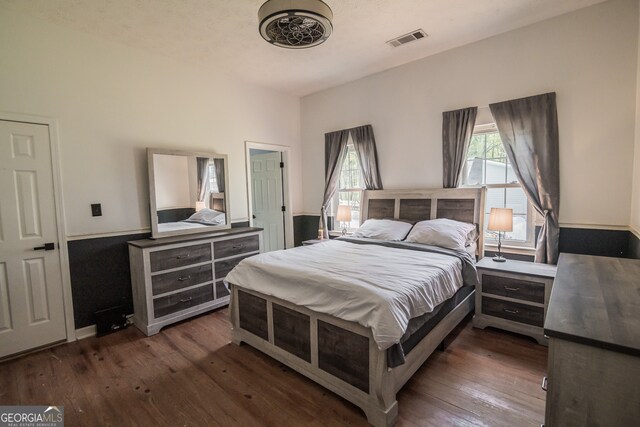 bedroom featuring dark wood-style floors and visible vents