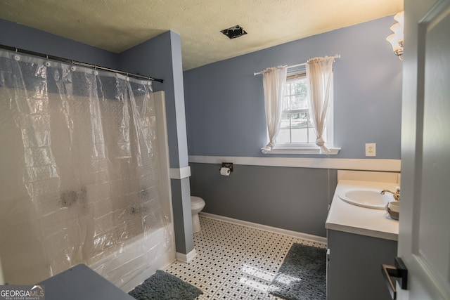 full bath featuring baseboards, a textured ceiling, toilet, and vanity