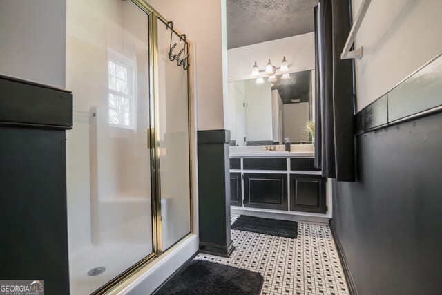 bathroom featuring a shower stall, tile patterned floors, and vanity