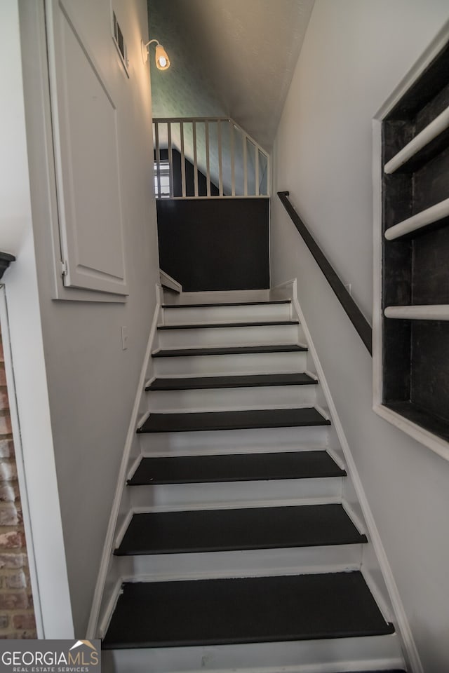 staircase featuring visible vents