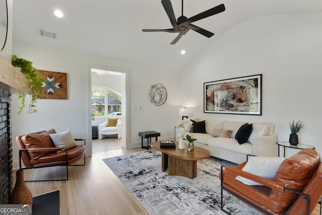 living area featuring a ceiling fan, a fireplace, wood finished floors, visible vents, and recessed lighting