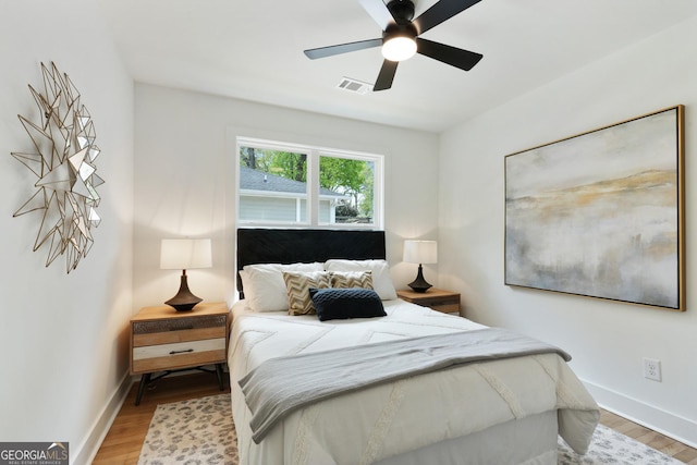 bedroom featuring baseboards, visible vents, and light wood-style flooring