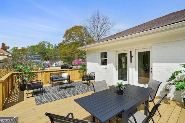 wooden terrace with an outdoor hangout area and outdoor dining area