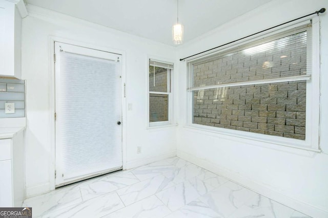 interior space with marble finish floor and baseboards