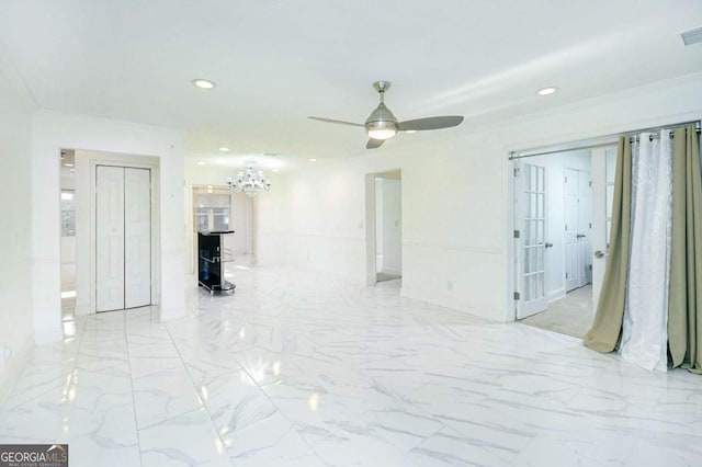 spare room with visible vents, crown molding, marble finish floor, recessed lighting, and ceiling fan with notable chandelier