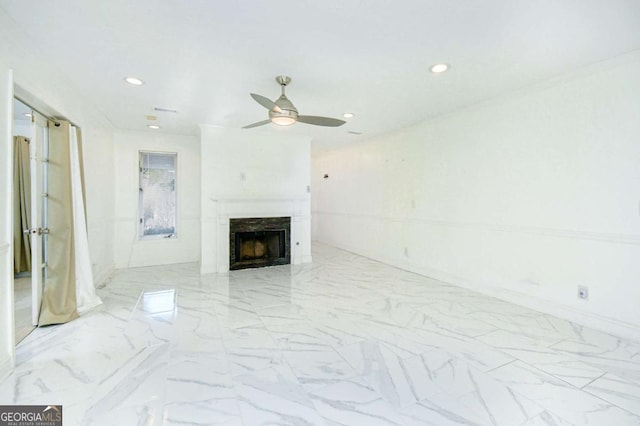unfurnished living room with marble finish floor, a ceiling fan, recessed lighting, and a premium fireplace
