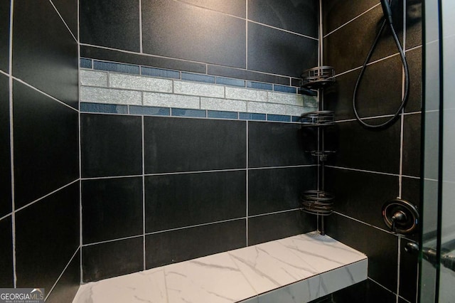 full bath with tiled shower