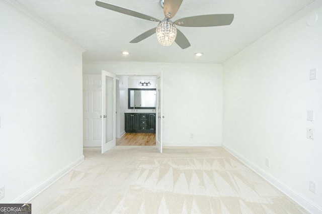 unfurnished room with ornamental molding, baseboards, light colored carpet, ceiling fan, and recessed lighting