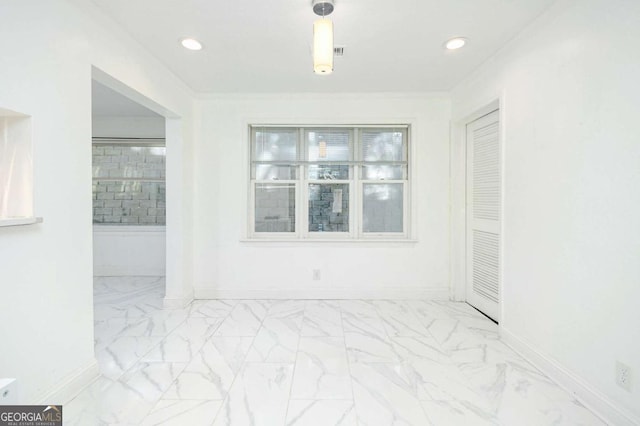 spare room featuring marble finish floor, baseboards, ornamental molding, and recessed lighting