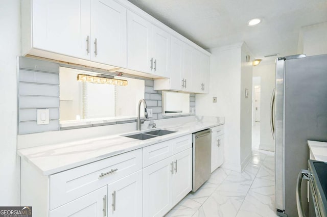 kitchen featuring tasteful backsplash, stainless steel appliances, marble finish floor, a sink, and white cabinets