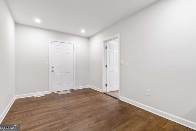interior space featuring baseboards, recessed lighting, and wood finished floors