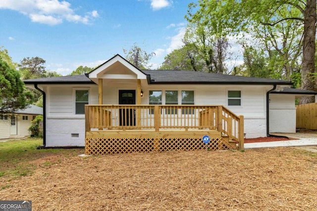 exterior space featuring brick siding, a wooden deck, and crawl space