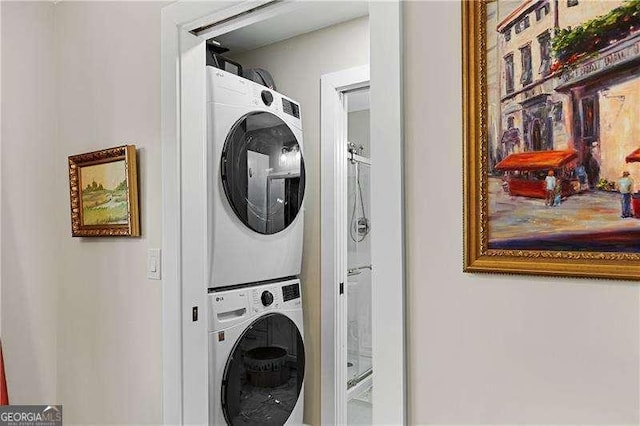 laundry area with stacked washer / dryer and laundry area