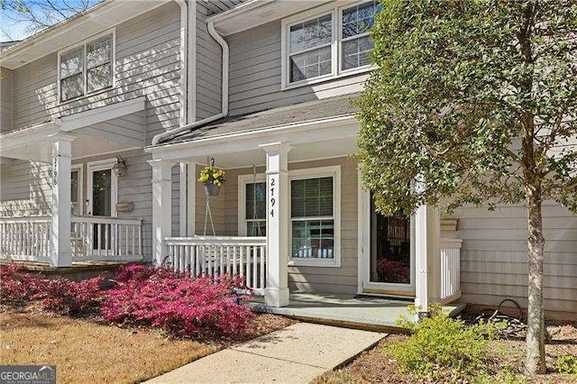 view of exterior entry with a porch