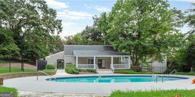 view of swimming pool featuring a fenced in pool and fence