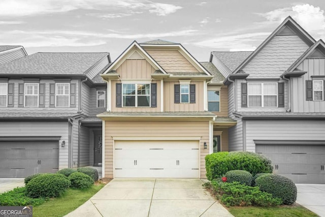 view of property featuring an attached garage, board and batten siding, and concrete driveway