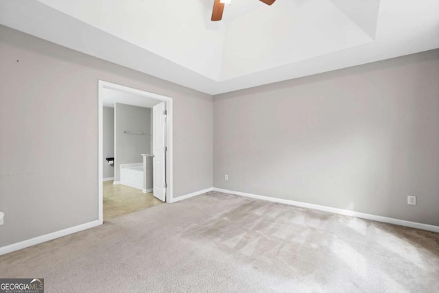 unfurnished bedroom featuring carpet floors, baseboards, lofted ceiling, and ceiling fan