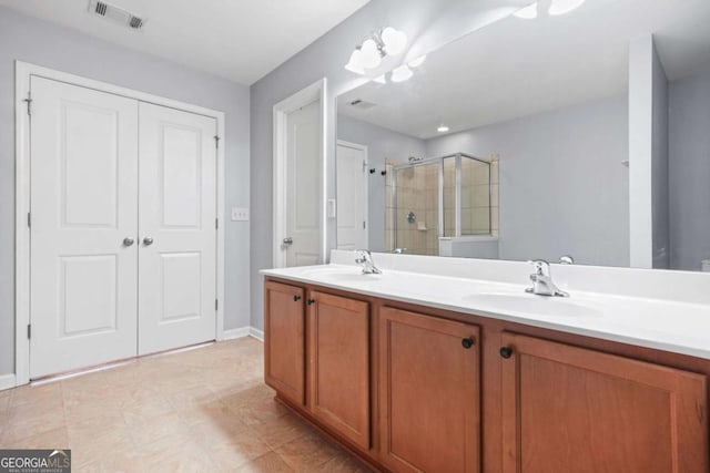 full bathroom with a sink, double vanity, visible vents, and a stall shower
