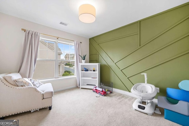 interior space with carpet flooring, baseboards, and visible vents
