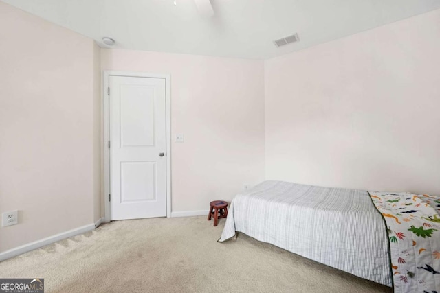 carpeted bedroom with baseboards, visible vents, and a ceiling fan