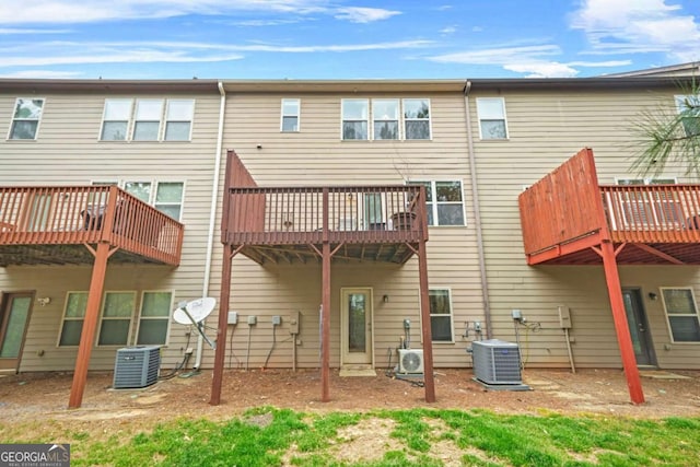 back of property with central air condition unit and ac unit