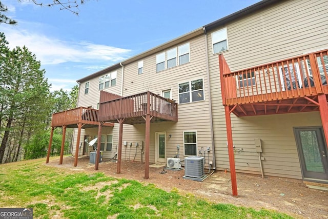 back of house featuring central AC unit and a deck