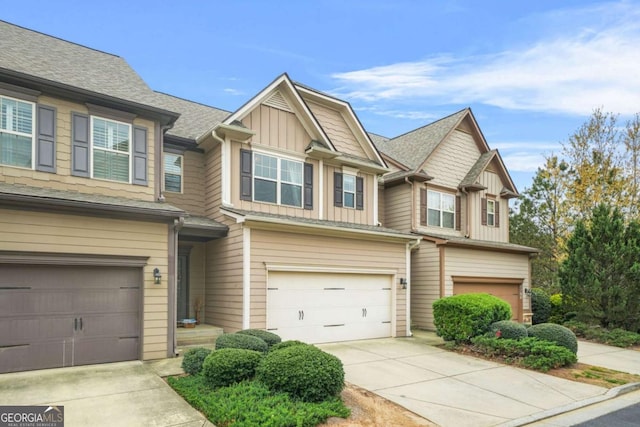 view of front of property featuring driveway, a shingled roof, a garage, and board and batten siding