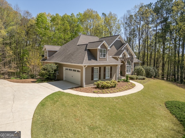 view of front of home with an attached garage, roof with shingles, a front yard, and concrete driveway