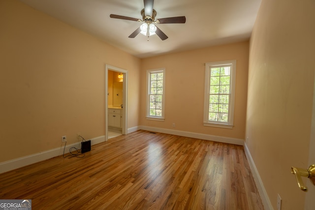 spare room featuring baseboards, a ceiling fan, and wood finished floors