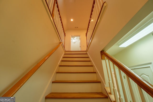 stairs featuring recessed lighting