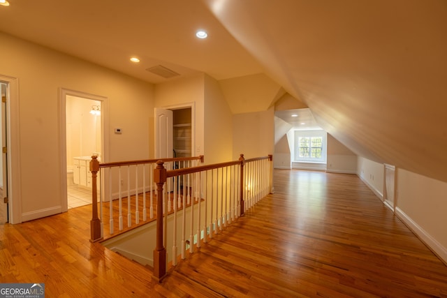 bonus room with recessed lighting, lofted ceiling, wood finished floors, visible vents, and baseboards