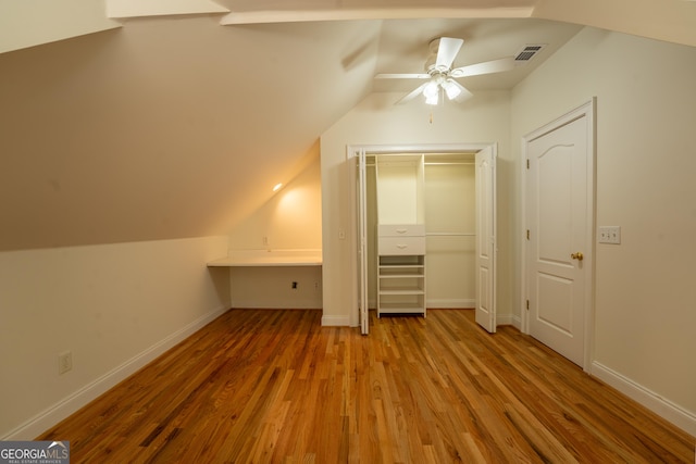 bonus room with baseboards, visible vents, lofted ceiling, wood finished floors, and ceiling fan