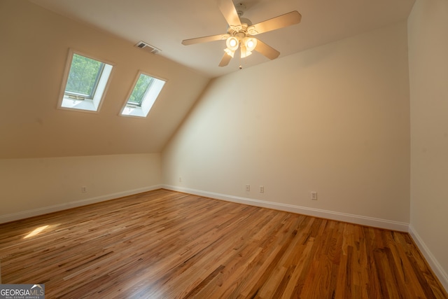 additional living space with visible vents, light wood-style flooring, baseboards, and a ceiling fan