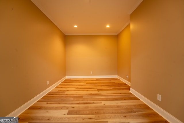spare room featuring baseboards, ornamental molding, light wood-type flooring, and recessed lighting