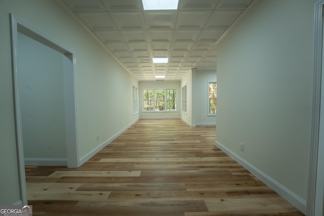 hallway with light wood finished floors and baseboards
