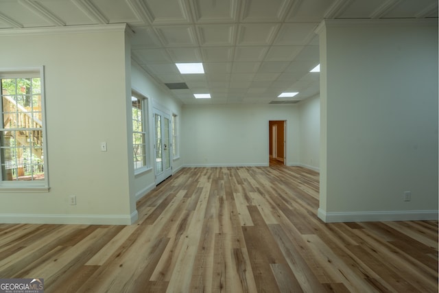 empty room featuring light wood finished floors and baseboards