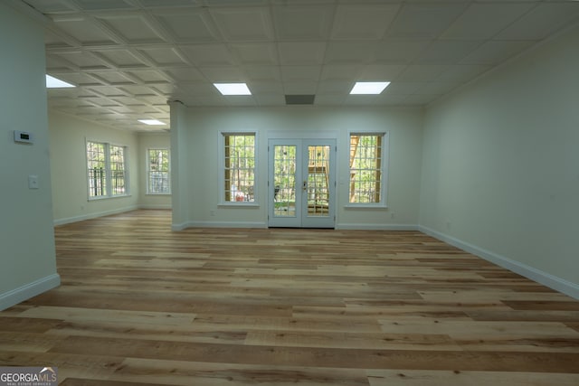 spare room with baseboards, a healthy amount of sunlight, and light wood-type flooring