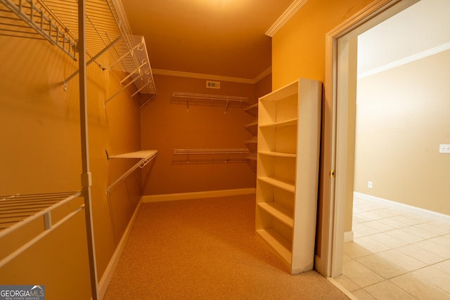 spacious closet with light tile patterned floors